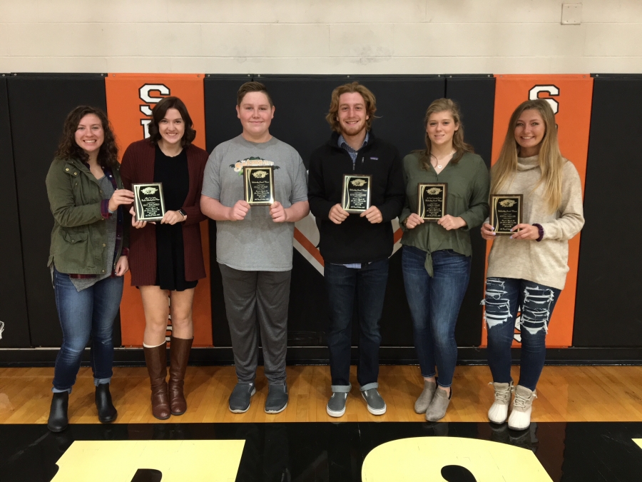 6 people holding plaques